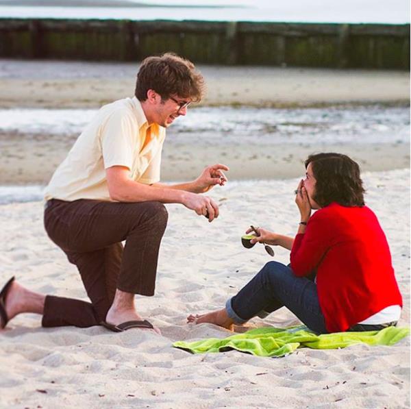 man proposes to girl with avocado. 