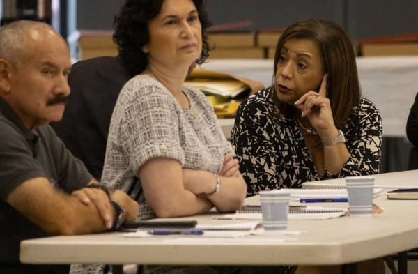 Iris Martinez, center, circuit court clerk of Cook County, speaks to other attendees during a Cook County Democrats slating meeting Tuesday.