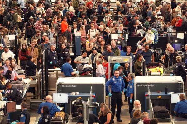 Travelers navigate a security checkpoint at Denver Internatio<em></em>nal Airport on November 22, 2022 in Denver, Colorado.