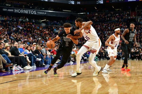 Kevin Durant #35 of the Phoenix Suns plays defense against Cameron Johnson #2 of the Brooklyn Nets