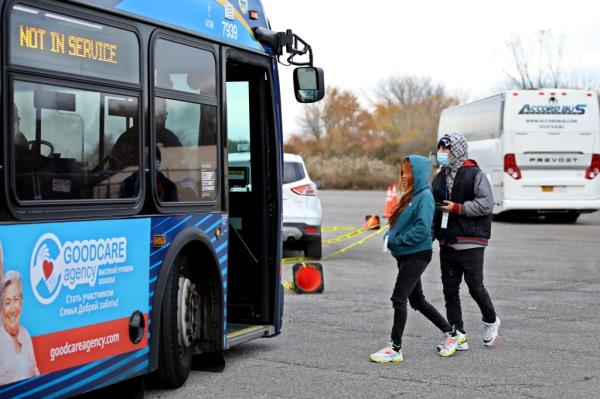 Migrants leave a shelter in Floyd Bennett Field in Brooklyn