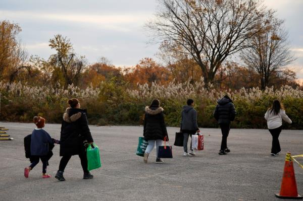 Migrants leave a shelter in Floyd Bennett Field in Brooklyn