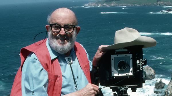 Ansel Adams with camera on bluff