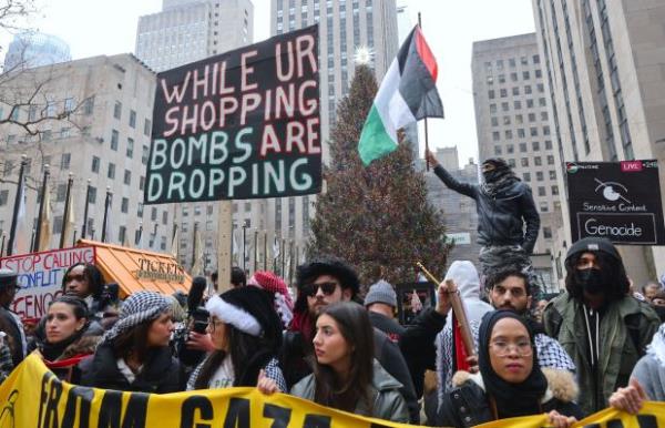 Pro-Palestinian protesters rally in front of the News Corporation building and near the Rockefeller Center Christmas tree, and march on 42nd Street, 5th and Park avenues on Monday, December 25, 2023, in New York City. (Selcuk Acar/Anadolu via Getty Images)