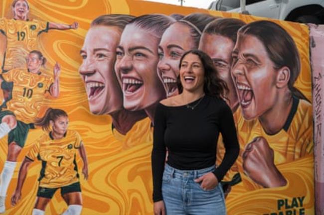 Artist Danielle Weber in front of her mural depicting the Matildas