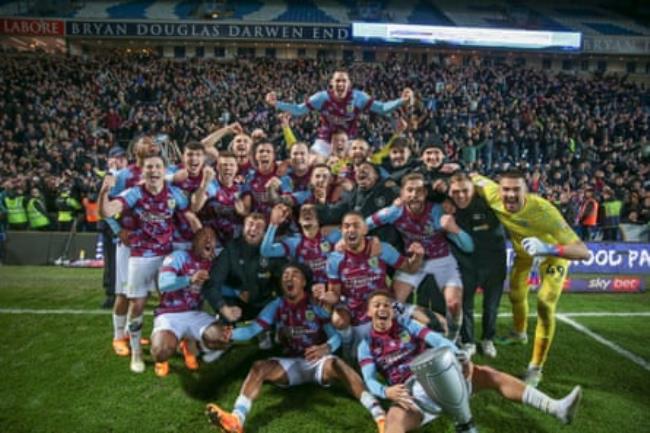 The Burnley players and fans celebrate promotion to the Premier League