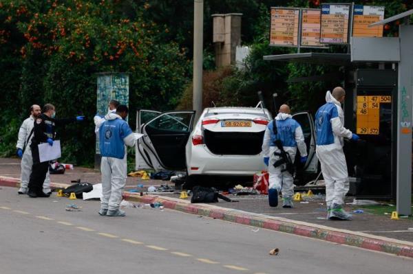 People work next to a vehicle following a suspected ramming attack in Raanana, Israel January 15, 2024. REUTERS/Ammar Awad