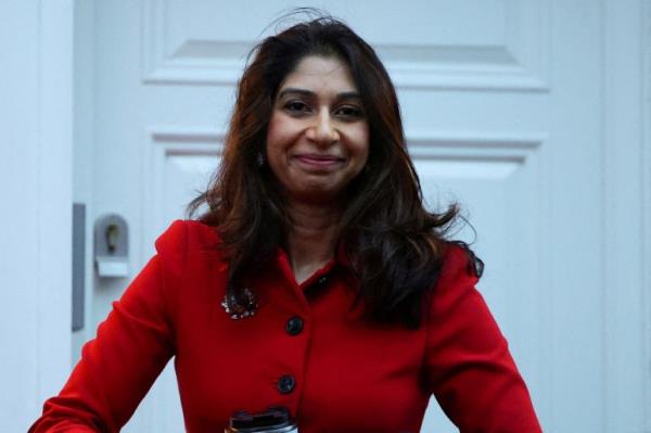 Britain's Home Secretary Suella Braverman walks outside her home