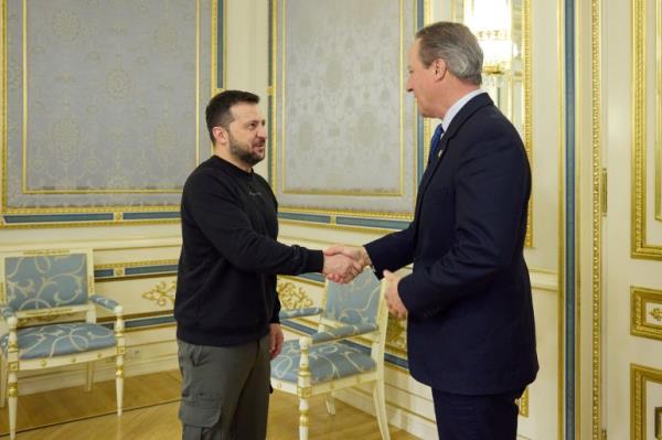 Ukraine's President Volodymyr Zelenskyy, left, welcomes UK Foreign Secretary David Cameron, in Kyiv