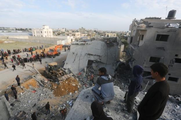 Workers unload bags of humanitarian aid.