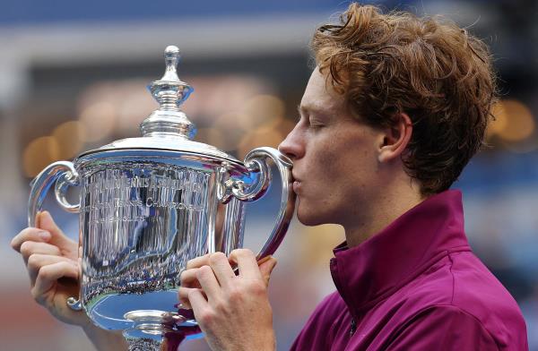 Italy's Jannik Sinner celebrates with the trophy after winning his final match against Taylor Fritz of the US