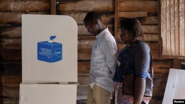 Voters stand by the poll booth at the Nyabusho<em></em>ngo Institute polling center on the second day of the Presidential election in Goma, North Kivu province of the Democratic Republic of Congo, Dec. 21, 2023.