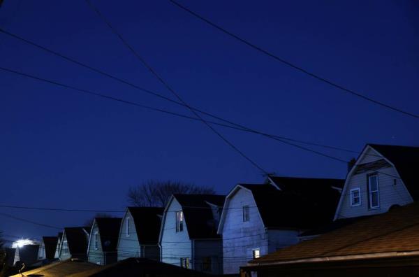 The backside of houses on South Avenue J at 104th Street in Chicago’s East Side neighborhood are seen at dusk on Nov. 29, 2023.   