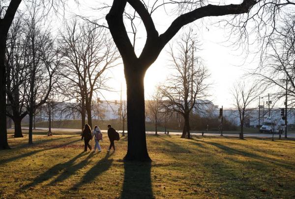 Students from George Washington High School walk through the adjacent Rowan Park at the end of the school day in Chicago’s East Side neighborhood on Nov. 29, 2023. The entrance to an industrial corridor at 116th Street and Avenue O is across the street from the park.   