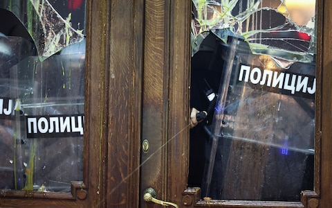 Protesters damaged the building's windows and doors 