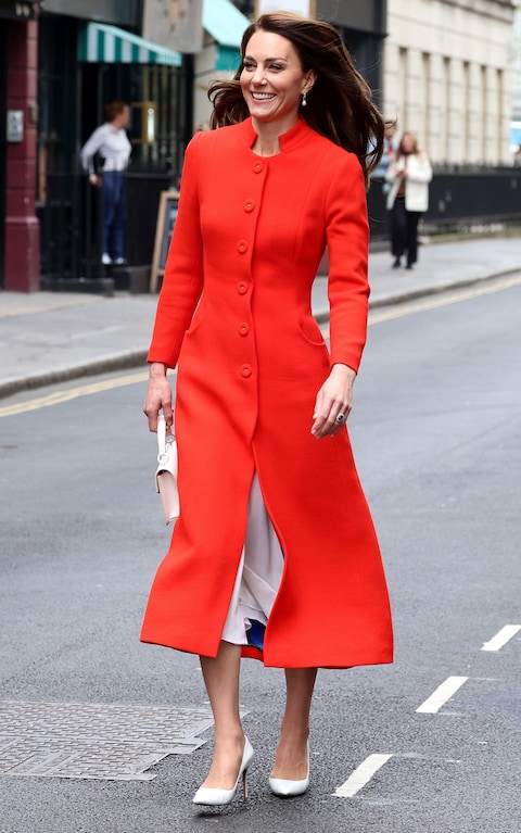 Wearing a red Epo<em></em>nine coat during a visit to the Dog & Duck Pub in Soho ahead of the Coronation